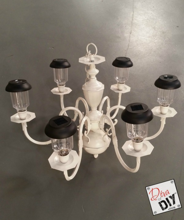 Looking for unique garden lighting? Make this solar chandelier using a chandelier and dollar store solar lights. Add character to your outdoor lighting!