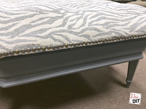 This coffee table ottoman is actually made out of an old table. Tutorial will show you how to make an ottoman and tuft this reupholstered ottoman DIY coffee table. 