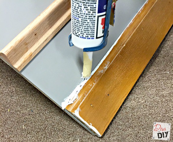 Cheap and easy Home Improvement DIY to add drama to builder grade baseboards by adding trim to your walls and painting the space between them.