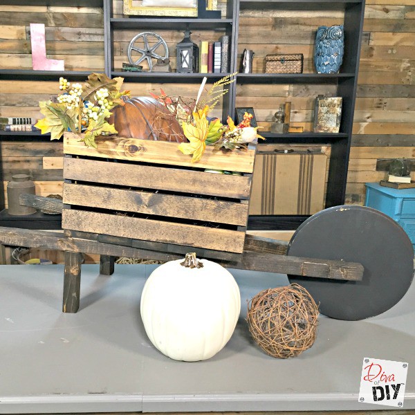 DIY planters that can be changed for the seasons! Make a wheelbarrow planter out of a wooden crate for real flowers or for Holiday Decorating! Think Fall!